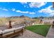 Backyard with pavers, artificial grass, a fire pit, and seating, with mountain views at 7428 W Montgomery Rd, Peoria, AZ 85383