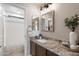 Elegant bathroom features dual mirrors, granite countertops, and plenty of light at 7428 W Montgomery Rd, Peoria, AZ 85383