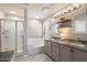 Well-lit bathroom features double sinks, granite countertops, and a separate shower at 7428 W Montgomery Rd, Peoria, AZ 85383