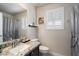 Modern bathroom features granite countertops, framed mirror, and natural light at 7428 W Montgomery Rd, Peoria, AZ 85383