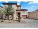 Charming two-story home featuring a tile roof, low maintenance desert landscaping, and an attached two car garage at 7428 W Montgomery Rd, Peoria, AZ 85383