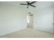 Bright bedroom featuring a ceiling fan, closet, and a view of an adjacent room at 7543 E Keats Ave, Mesa, AZ 85209