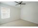 Well-lit bedroom with neutral carpet and a large window, creating a bright and airy space at 7543 E Keats Ave, Mesa, AZ 85209