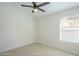 Well-lit bedroom with neutral carpet, a large window, and blank walls for personalization at 7543 E Keats Ave, Mesa, AZ 85209