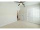 Bright bedroom featuring a ceiling fan, closet, and a view of an adjacent room at 7543 E Keats Ave, Mesa, AZ 85209