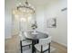 Bright dining room with a modern chandelier and a table that seats six, adjacent to the entryway at 7543 E Keats Ave, Mesa, AZ 85209