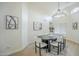 Well-lit dining room featuring a modern chandelier, artwork, and seating for six at 7543 E Keats Ave, Mesa, AZ 85209