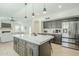 Open layout showing kitchen island, stainless appliances, and a seamless transition to the living space at 7543 E Keats Ave, Mesa, AZ 85209