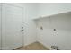 A basic, unfinished laundry room with white walls, tile floor, and essential hookups at 7543 E Keats Ave, Mesa, AZ 85209