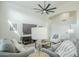 Bright, open living room featuring a modern ceiling fan, plush sofas, and neutral decor at 7543 E Keats Ave, Mesa, AZ 85209