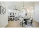 Open-concept living room and dining area with modern gray sofa, dining table, and hardwood floors at 7543 E Keats Ave, Mesa, AZ 85209