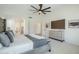 Main bedroom showcasing an open en-suite bathroom, and a large entertainment console at 7543 E Keats Ave, Mesa, AZ 85209