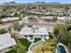 Aerial view of a home with pool and landscaping in a residential neighborhood near mountains and golf course at 8405 N Via Mia --, Scottsdale, AZ 85258