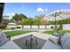 Inviting backyard featuring a pool, well-manicured lawn, and comfortable patio seating area under a white umbrella at 8405 N Via Mia --, Scottsdale, AZ 85258