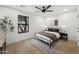 Cozy bedroom features wood floors, a ceiling fan, and a window framing an outdoor view, perfect for relaxing at 8405 N Via Mia --, Scottsdale, AZ 85258