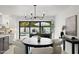 Dining room with modern chandelier, white chairs, and outdoor view of the pool at 8405 N Via Mia --, Scottsdale, AZ 85258