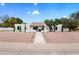 Inviting single-story home with desert landscaping, a charming pathway, and mature trees in the front yard at 8405 N Via Mia --, Scottsdale, AZ 85258