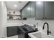 Modern laundry room featuring green cabinets, quartz countertops, patterned floors, and stainless steel washer and dryer at 8405 N Via Mia --, Scottsdale, AZ 85258