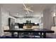 Open dining area featuring modern lighting and seamlessly connects the kitchen and living spaces at 872 W Desert Sky Dr, San Tan Valley, AZ 85143