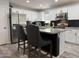 Modern kitchen featuring stainless steel appliances, granite countertops, a kitchen island and white cabinetry at 872 W Desert Sky Dr, San Tan Valley, AZ 85143