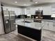 Modern kitchen featuring stainless steel appliances, granite countertops, a kitchen island and white cabinetry at 872 W Desert Sky Dr, San Tan Valley, AZ 85143