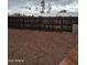 A large rock filled yard with a dark wooden fence bordering the property at 8727 N 35Th Dr, Phoenix, AZ 85051