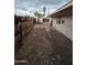 A backyard includes a covered patio, a small shed, a fence, and rock landscaping at 8727 N 35Th Dr, Phoenix, AZ 85051