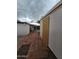 Backyard view of a home under a cloudy sky, with a brick patio and boarded up window at 8727 N 35Th Dr, Phoenix, AZ 85051