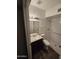 Updated bathroom featuring white tile surround and dark vanity at 8727 N 35Th Dr, Phoenix, AZ 85051