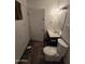 Bathroom with dark vanity and white toilet and tiled floors at 8727 N 35Th Dr, Phoenix, AZ 85051