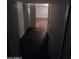 Hallway with dark flooring and an open doorway to another room at 8727 N 35Th Dr, Phoenix, AZ 85051