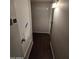 Hallway features light grey walls and dark brown faux hardwood floors at 8727 N 35Th Dr, Phoenix, AZ 85051