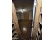 An open living room space, viewed from inside a closet, features wood-look floors and light-toned walls at 8727 N 35Th Dr, Phoenix, AZ 85051