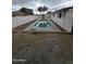 Fenced backyard featuring refreshing pool, gravel landscaping, and block wall at 8727 N 35Th Dr, Phoenix, AZ 85051