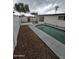 Backyard pool featuring concrete trim, metal safety rails, and gated access at 8727 N 35Th Dr, Phoenix, AZ 85051