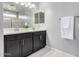 Bathroom features double vanity, a large mirror, and a shower behind at 8836 S 165Th Ave, Goodyear, AZ 85338