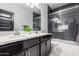 Bathroom boasts a double vanity, framed mirror and modern-style shower at 8836 S 165Th Ave, Goodyear, AZ 85338