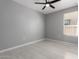 This bedroom features tile floors, a ceiling fan, and a window with blinds at 8836 S 165Th Ave, Goodyear, AZ 85338