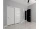 Bedroom with tile floors features closet and entry doors with ceiling fan at 8836 S 165Th Ave, Goodyear, AZ 85338