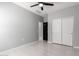 Bedroom features tile floors, a ceiling fan, and closet and entry doors at 8836 S 165Th Ave, Goodyear, AZ 85338