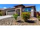 Attractive single-level home featuring a stone entryway, desert landscaping, and a convenient attached two-car garage at 8836 S 165Th Ave, Goodyear, AZ 85338