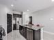 Modern kitchen featuring dark cabinets, granite countertops, an island, and stainless steel appliances at 8836 S 165Th Ave, Goodyear, AZ 85338