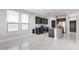 A modern open-concept kitchen, featuring sleek black cabinetry and an island with granite countertop at 8836 S 165Th Ave, Goodyear, AZ 85338