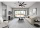 Bright living room with modern ceiling fan, sliding glass doors, and neutral decor at 8836 S 165Th Ave, Goodyear, AZ 85338