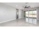 Bright living room featuring a ceiling fan, gray walls, and sliding glass doors leading to the outside at 8836 S 165Th Ave, Goodyear, AZ 85338