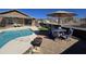 Backyard patio with a pool, dining area, and landscaped yard for outdoor enjoyment at 8965 E Red Mountain Ln, Gold Canyon, AZ 85118