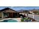 A backyard featuring a pool, outdoor seating, mountain views, and a well-maintained landscape at 8965 E Red Mountain Ln, Gold Canyon, AZ 85118