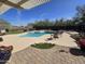 A backyard featuring a free form pool, patio, and manicured landscaping at 8965 E Red Mountain Ln, Gold Canyon, AZ 85118