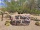 Rock sign for The Foothills at Gold Canyon entrance and desert landscaping at 8965 E Red Mountain Ln, Gold Canyon, AZ 85118