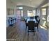 Well lit dining room featuring wood floors, large windows, and an open floor plan at 8965 E Red Mountain Ln, Gold Canyon, AZ 85118